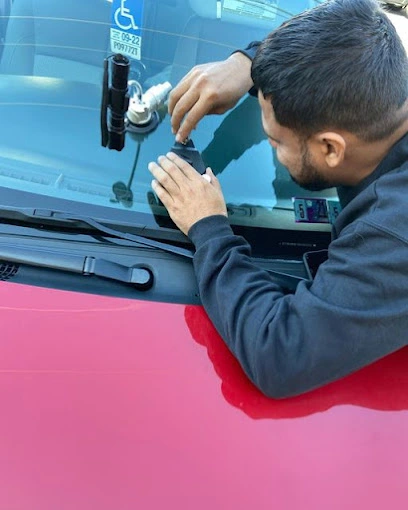 An autoglass technician repairing a chipped windshield